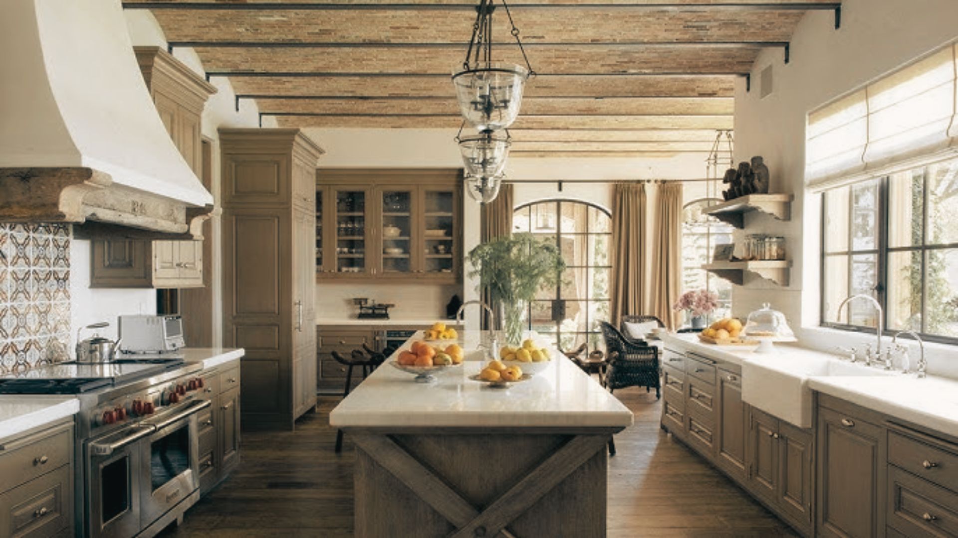 Farmhouse-Style white kitchen with glass-front cabinets and stainless steel refrigerator.