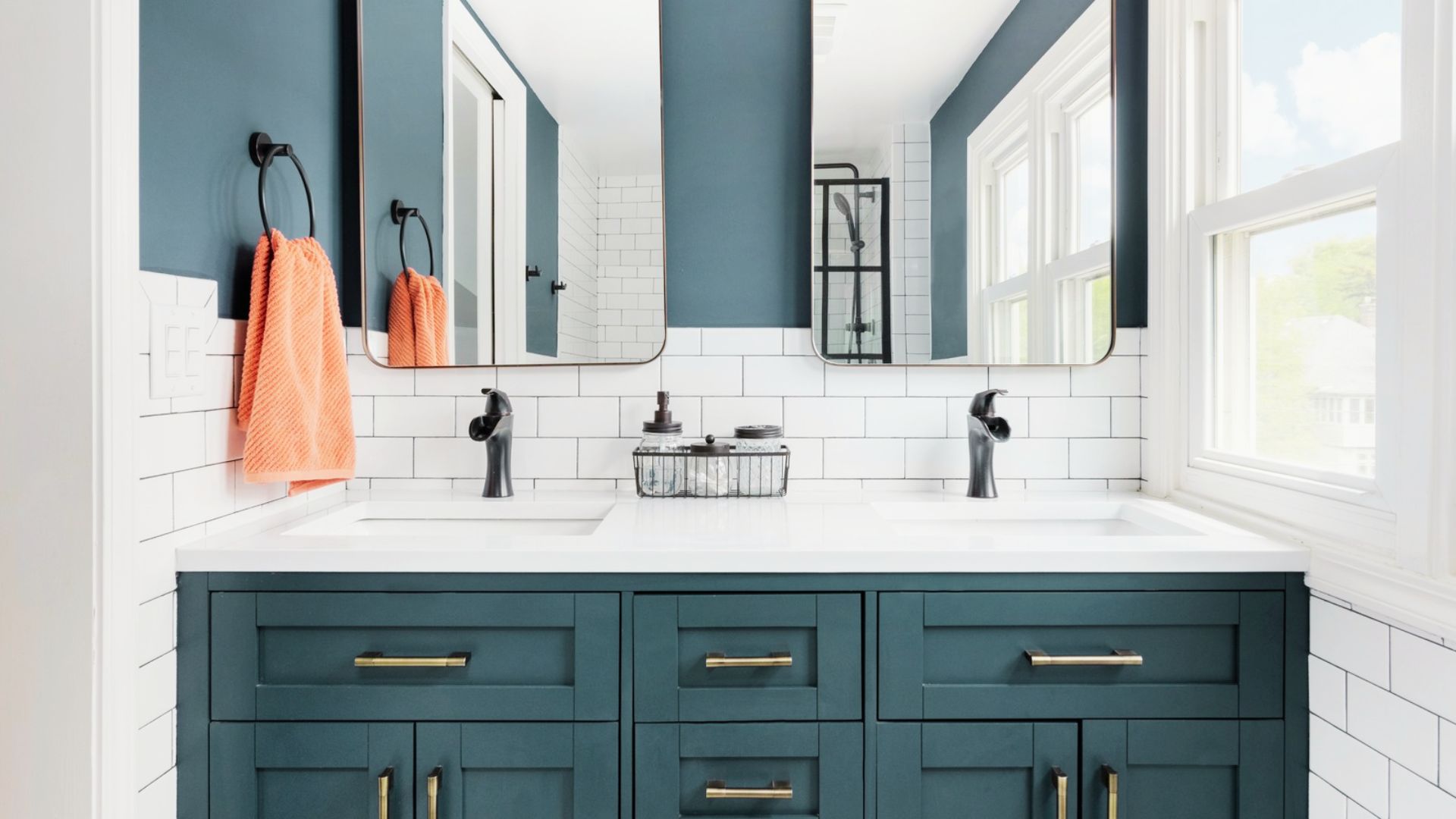 Modern double-sink vanity refinished in deep teal with brass hardware and subway tile backsplash.