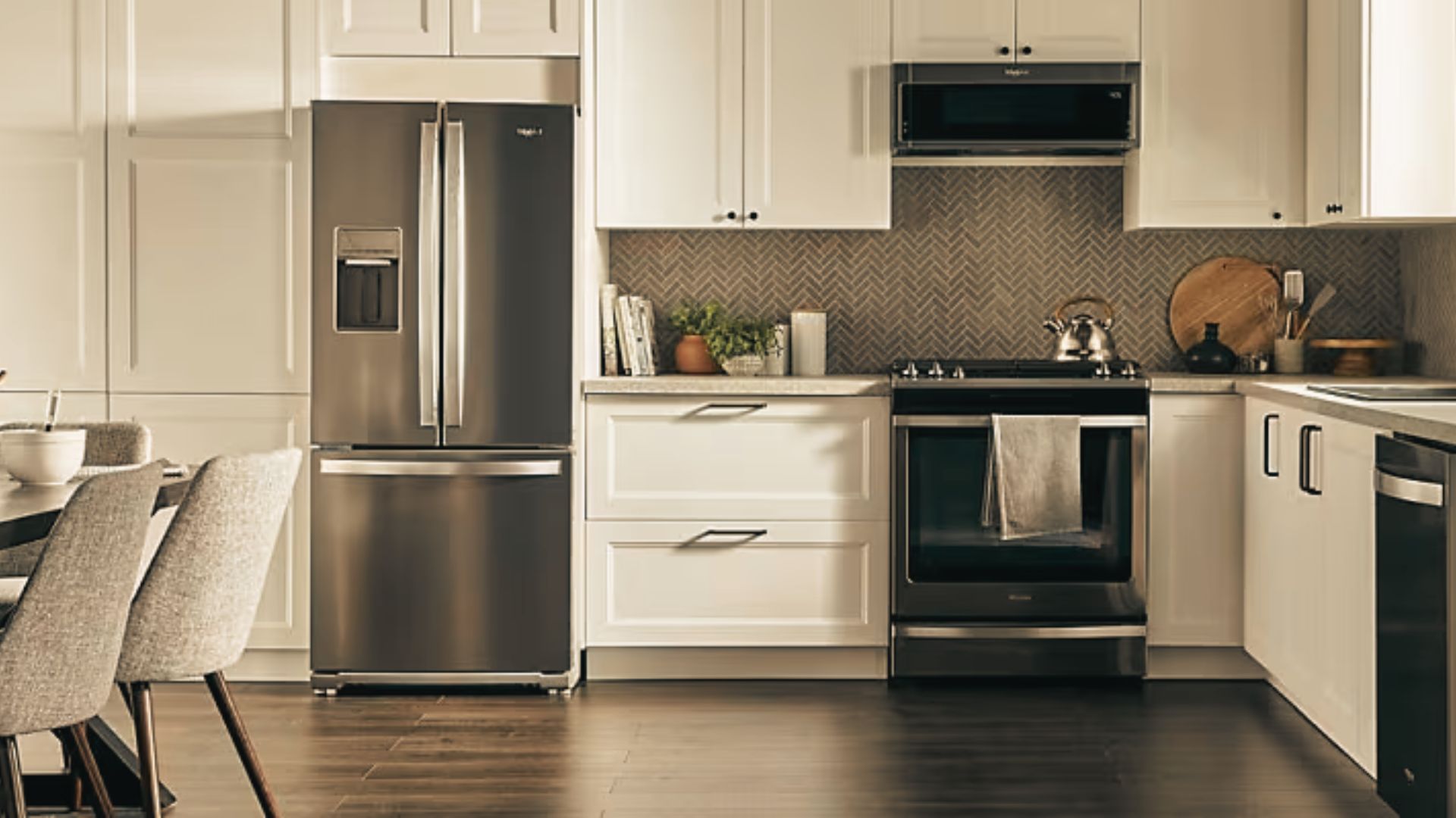 Traditional white kitchen with glass-front cabinets and stainless steel refrigerator.