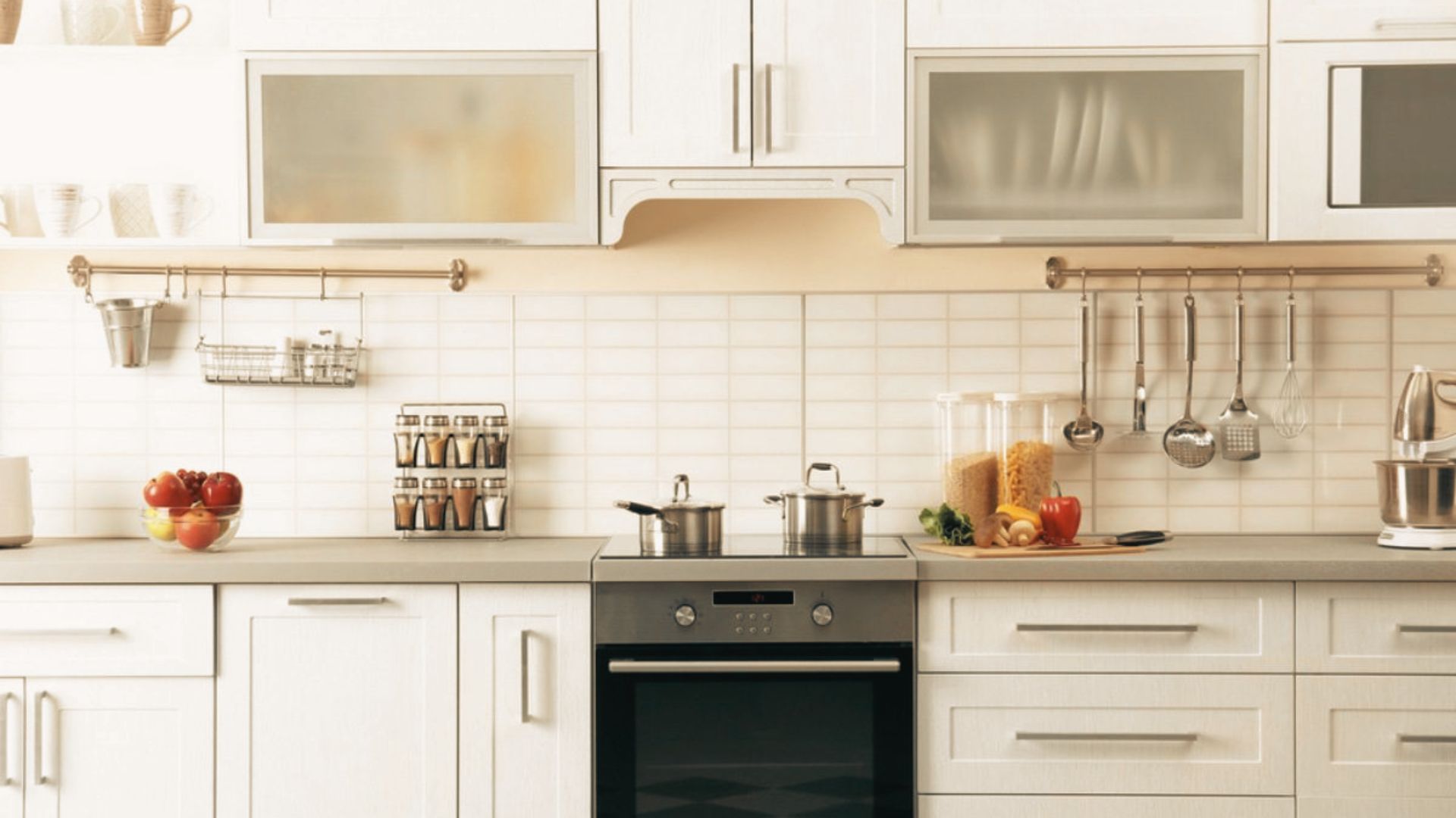 Minimal modern white kitchen with stainless steel appliances.