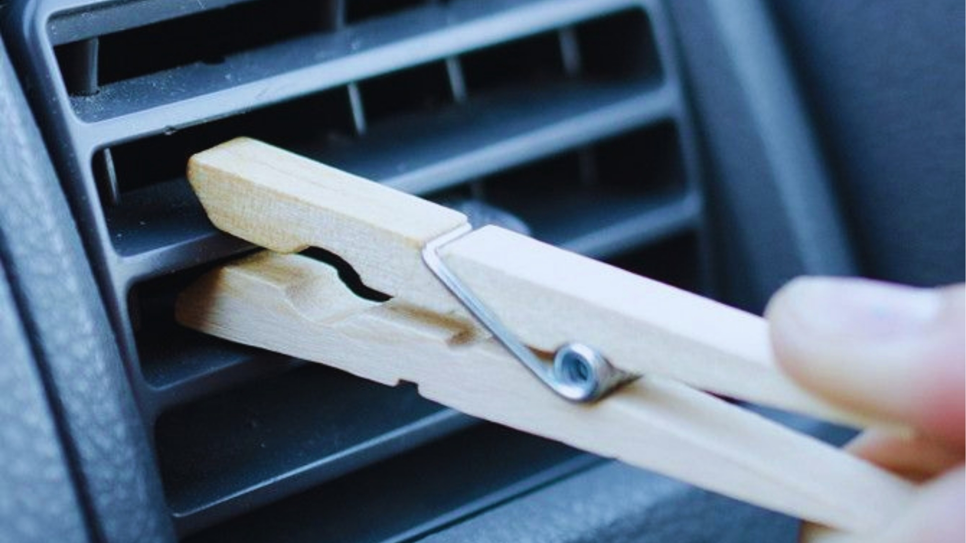 clothespin with crucial oil clipped on car air vent spreading scent through airflow across room space