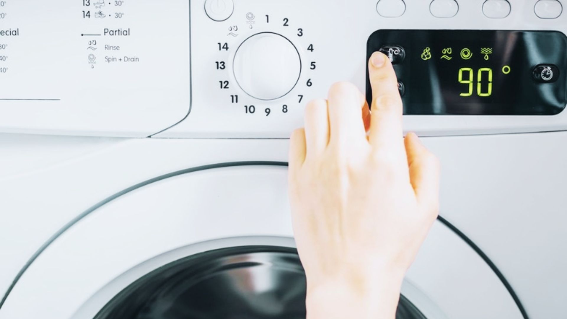 Finger selecting 90 degrees on a washer control panel to activate the sanitize cycle’s high-temperature wash