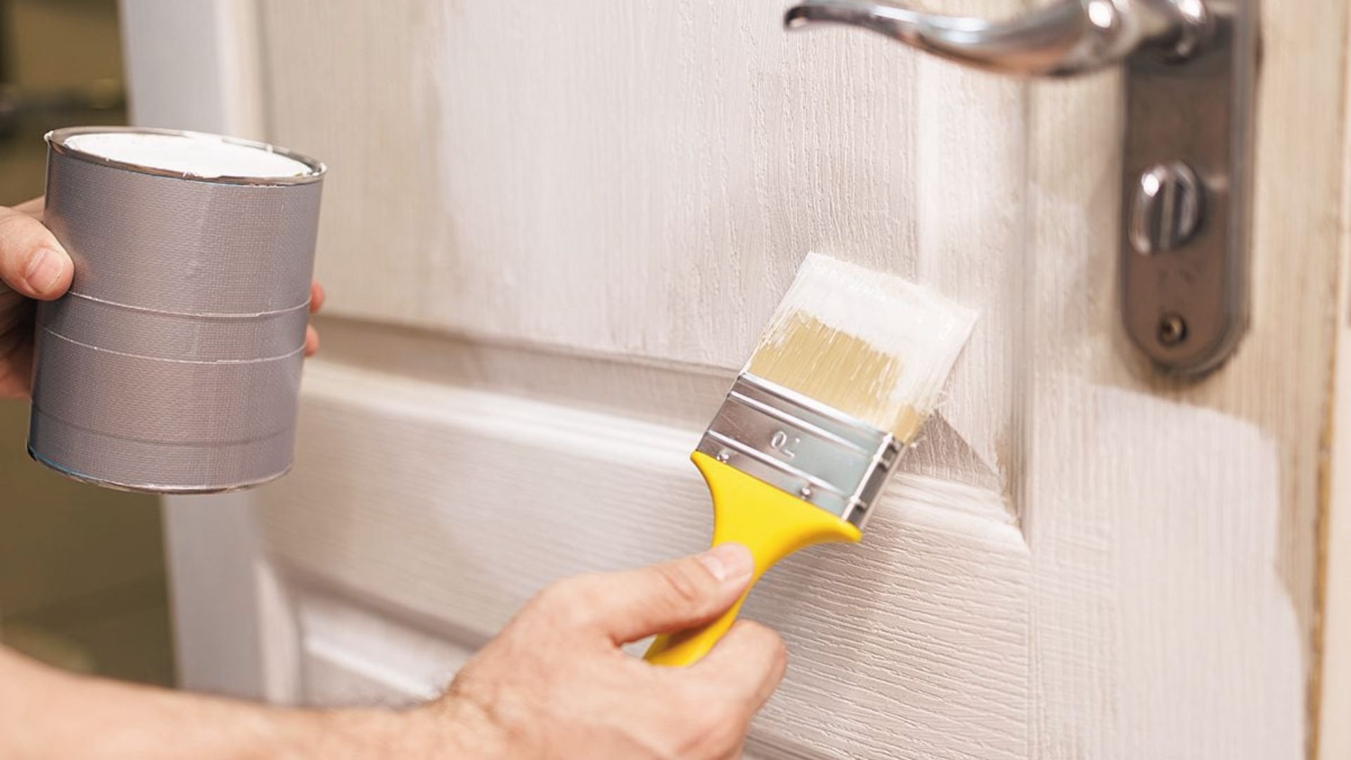 Refresh old doors fast on a budget using white paint and a brush for a clean, modern look.