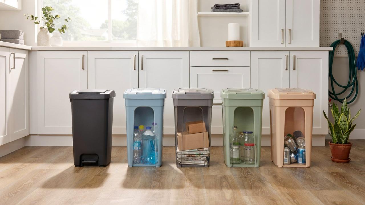 Properly organized household trash and recycling bins stored in a clean, well-ventilated home space.