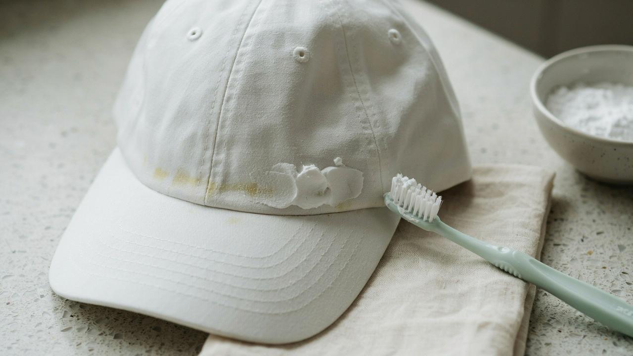 Baking soda paste applied to remove sweat stains from a hat.